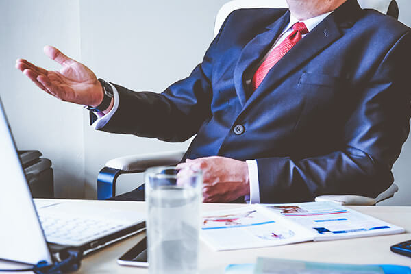 a sitting man in a blue suit